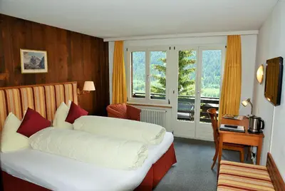 Ein Bett oder Betten in einem Zimmer der Unterkunft Hotel Tschuggen
