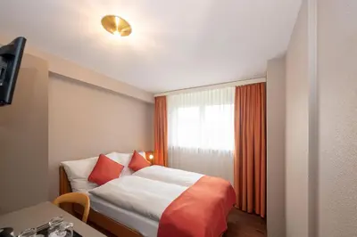 Ein Bett oder Betten in einem Zimmer der Unterkunft Hotel Alex Business & SPA
