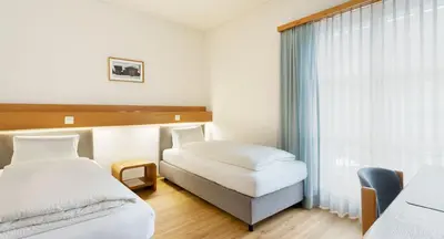 Ein Bett oder Betten in einem Zimmer der Unterkunft Hotel & Bildungshaus St. Jodern