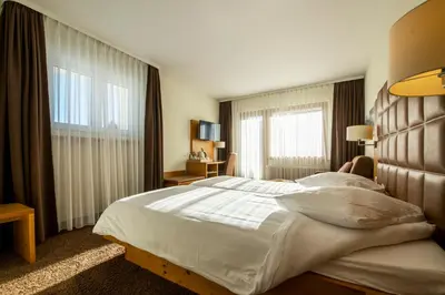 Ein Bett oder Betten in einem Zimmer der Unterkunft Hotel Olympic - Montana Center