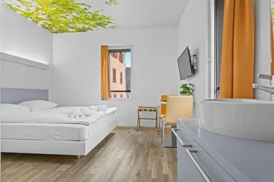 Ein Bett oder Betten in einem Zimmer der Unterkunft Hôtel de la Poste Sierre