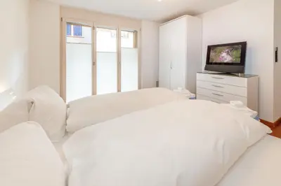 Ein Bett oder Betten in einem Zimmer der Unterkunft Casa Della Luce Apartments by Zermatt Premium Apartments