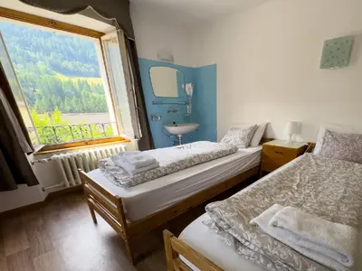 Ein Bett oder Betten in einem Zimmer der Unterkunft Hotel Des Alpes - Restaurant & Pizzeria