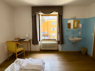 Ein Bett oder Betten in einem Zimmer der Unterkunft Hotel Des Alpes - Restaurant & Pizzeria