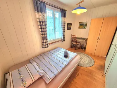 Ein Bett oder Betten in einem Zimmer der Unterkunft CASA UNO Heimeliges Chalet mitten in Spiez