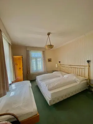 Ein Bett oder Betten in einem Zimmer der Unterkunft Hotel De La Paix