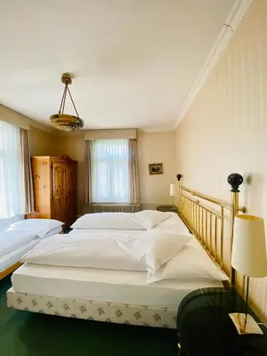 Ein Bett oder Betten in einem Zimmer der Unterkunft Hotel De La Paix