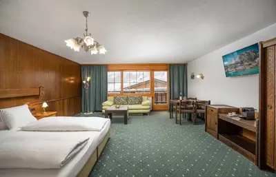 Ein Bett oder Betten in einem Zimmer der Unterkunft Grichting Hotel & Serviced Apartments