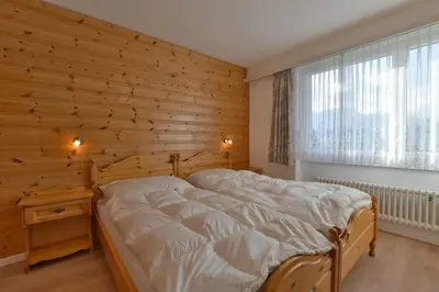 Ein Bett oder Betten in einem Zimmer der Unterkunft Waldesrand Bättlihorn
