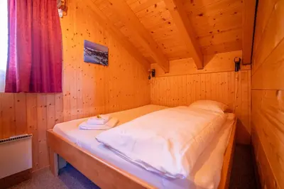 Ein Bett oder Betten in einem Zimmer der Unterkunft Chalet Collini