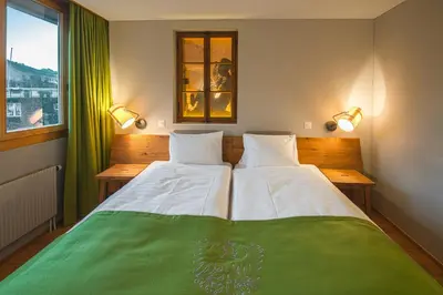 Ein Bett oder Betten in einem Zimmer der Unterkunft Blasers Hotel Restaurant Chocolat