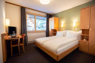 Ein Bett oder Betten in einem Zimmer der Unterkunft Hotel Jungfraublick