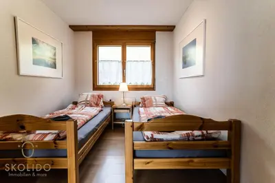 Ein Bett oder Betten in einem Zimmer der Unterkunft Haus Lotus, Riederalp Moosfluhbahn