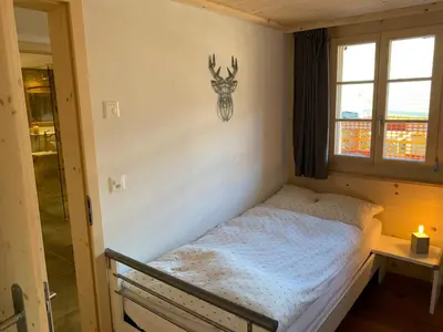 Ein Bett oder Betten in einem Zimmer der Unterkunft Büehl Lenk