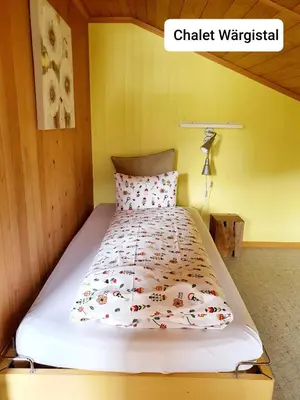 Ein Bett oder Betten in einem Zimmer der Unterkunft Chalet Wärgistal