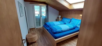 Ein Bett oder Betten in einem Zimmer der Unterkunft Chalet Sunnmätteli