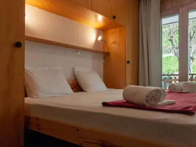 Ein Bett oder Betten in einem Zimmer der Unterkunft Apartment Les Crêtes 1-4 by Interhome