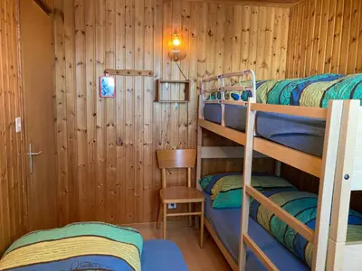 Ein Bett oder Betten in einem Zimmer der Unterkunft Chalet Sunnuterrasse
