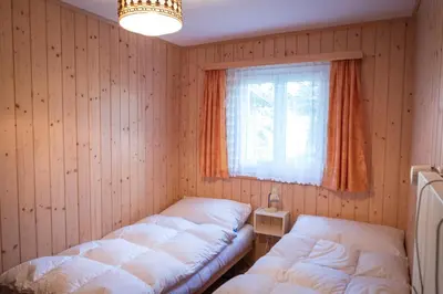 Ein Bett oder Betten in einem Zimmer der Unterkunft Chalet Sunnuterrasse