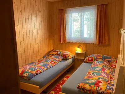 Ein Bett oder Betten in einem Zimmer der Unterkunft Chalet Sunnuterrasse