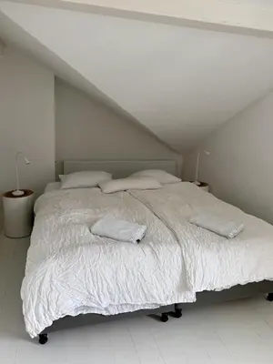 Ein Bett oder Betten in einem Zimmer der Unterkunft NI FRAVI Holiday Apartments, Interlaken West