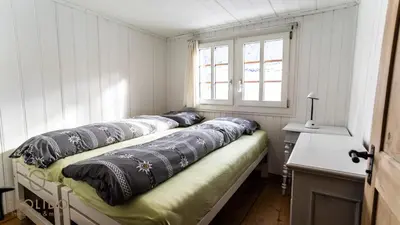 Ein Bett oder Betten in einem Zimmer der Unterkunft Heimeliges Walliserhaus