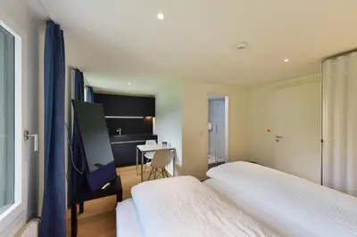 Ein Bett oder Betten in einem Zimmer der Unterkunft Bellevue Hotel & Apartments