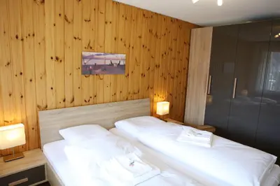 Ein Bett oder Betten in einem Zimmer der Unterkunft Monte Rosa Apartments Täsch
